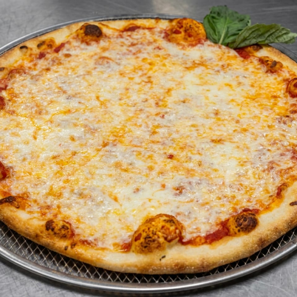Cheese pizza with a golden-brown crust and basil garnish on a wire rack atop a stainless steel surface.